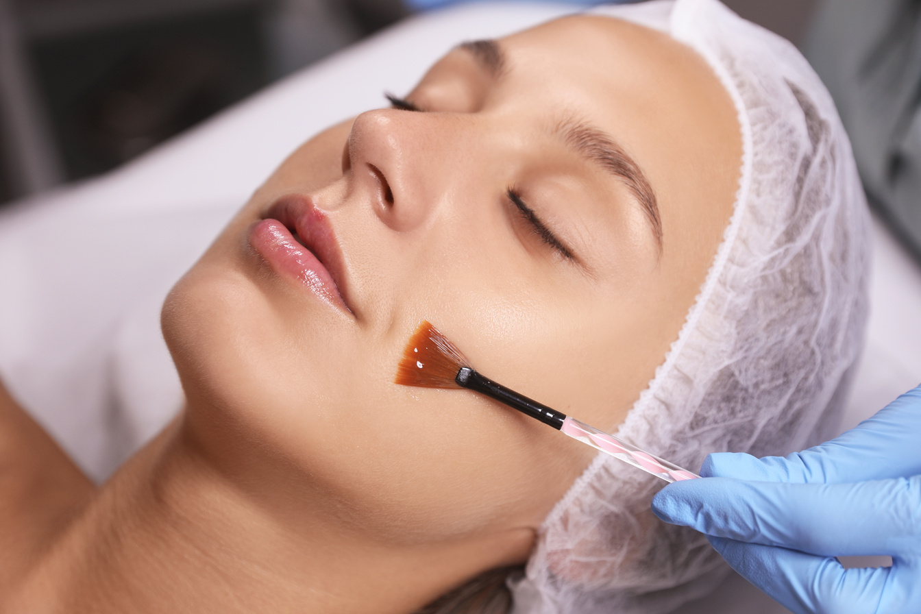 Cosmetologist Applying Chemical Peel Product on Client's Face in